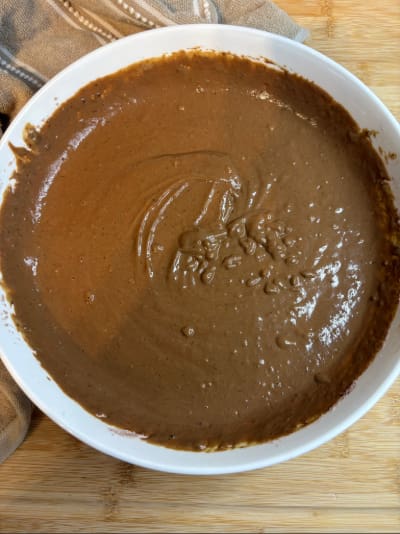 Thick chocolate batter in white bowl