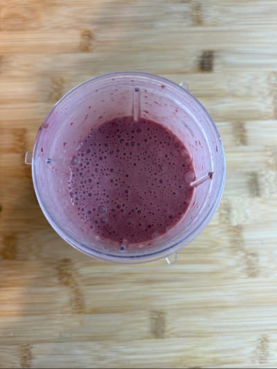 Top view of pink berry smoothie in blender