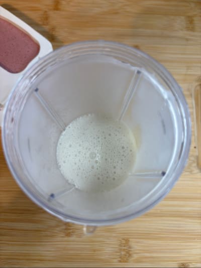Top view of blender cup with frothy liquid