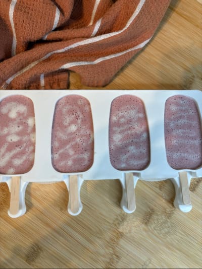 Four homemade berry popsicles in mold