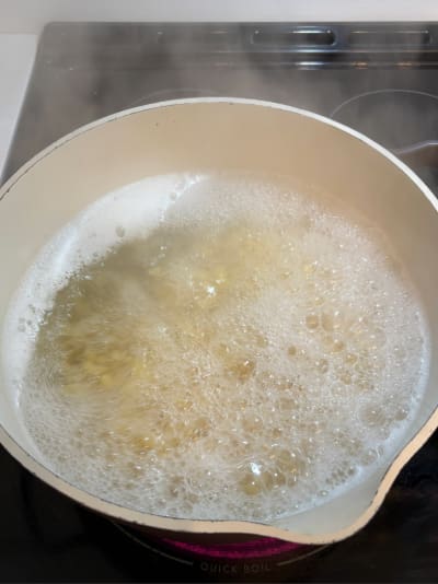 White pot boiling pasta on stovetop